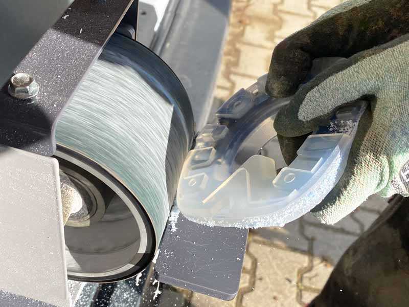 adjusting a horse shoe with plastic sheath using a belt grinder
