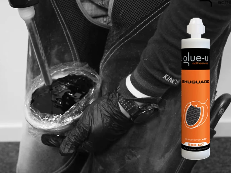 In the background you can see a screenshot from Glue-U's Tips and Tricks video for the application of SHUGUARD. In the foreground the SHUGUARD cartridge is visible.