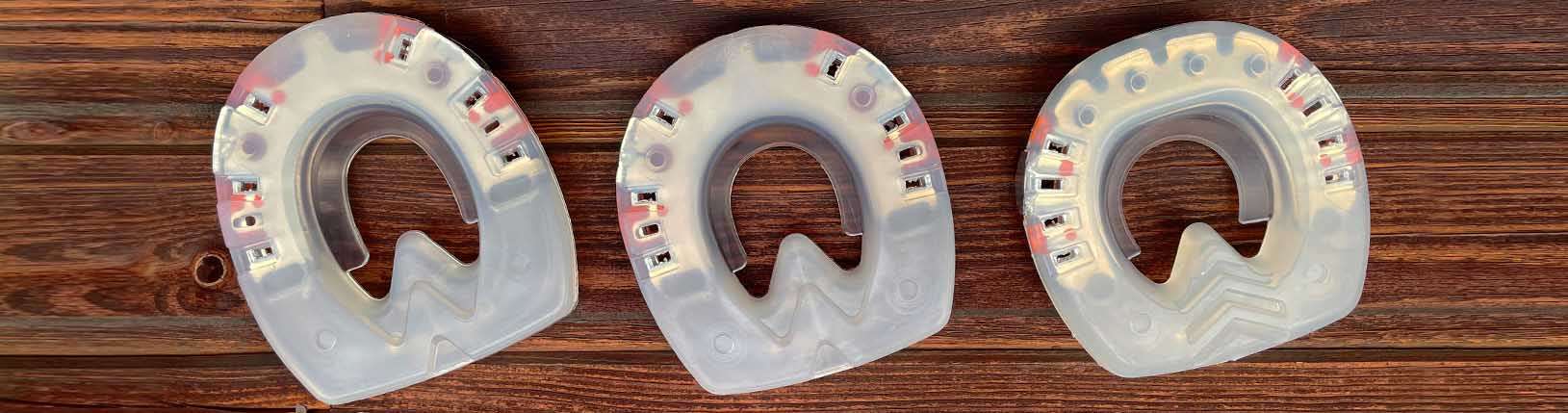three different shapes of urethane horseshoes – round, oval and straight toe shape