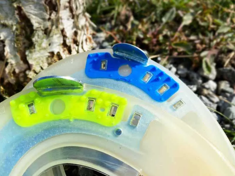 Close-up of a horseshoe made from recycled plastic with blue and yellow stud inserts.