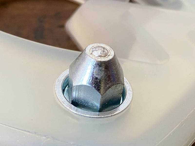 Ice studs in the stud hole of a horseshoe with a plastic coating