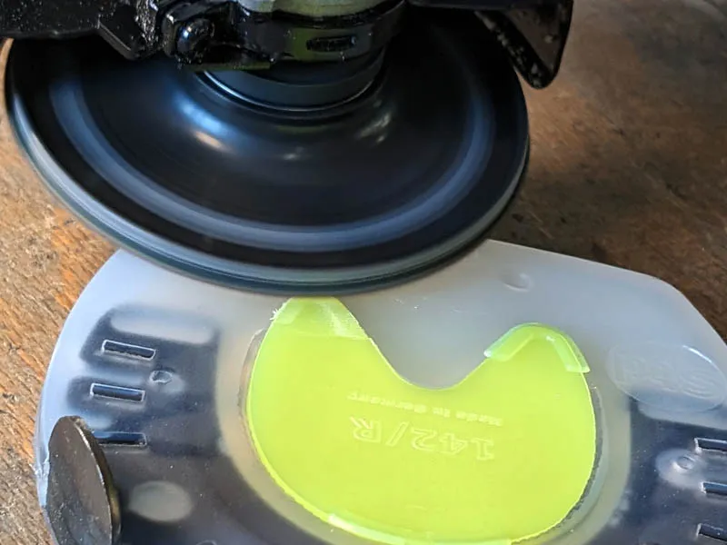 The farrier grinds down the hooks of the click system on the sole protector.