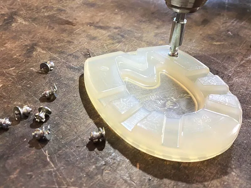 urethane pony horseshoe with small grip studs (spikes) similar to tungsten pins on steel shoes for added grip.