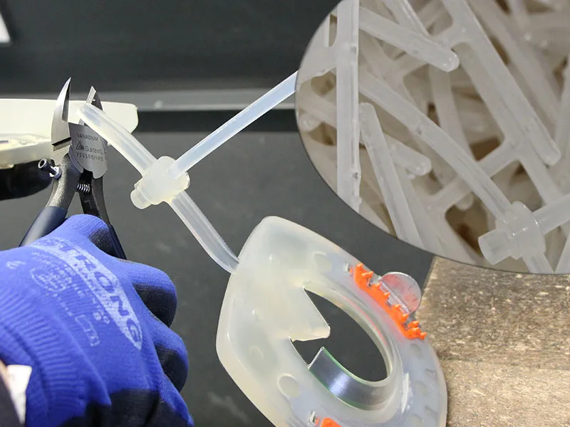 Illustrative image showing the clean separation of sprue waste generated during the injection molding process of composite horseshoes.