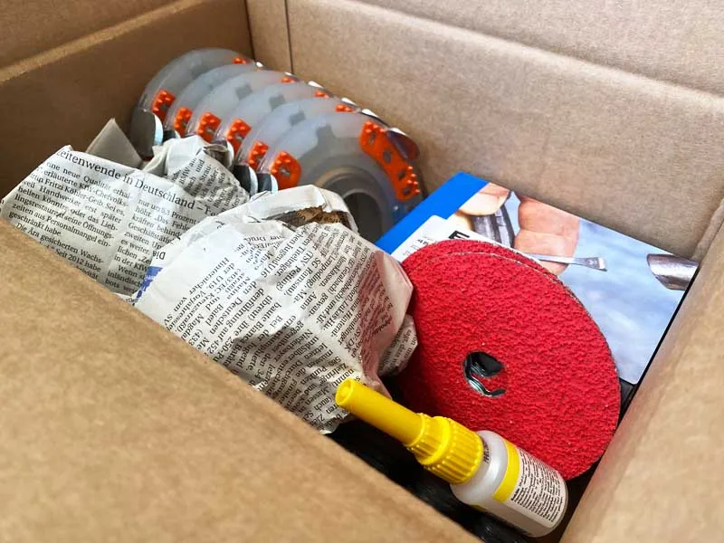 Customer order with composite horseshoes, grinding wheels, horseshoe nails, superglue and filling material from old newspapers.