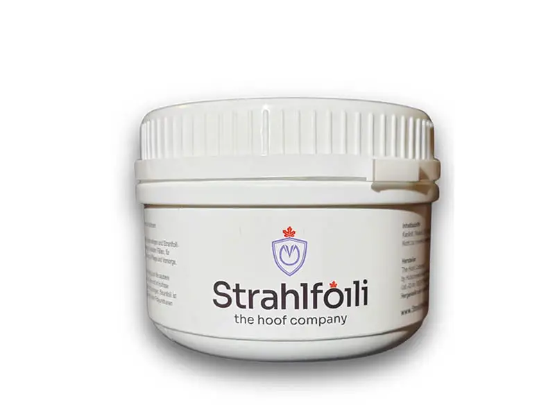 Close-up of the Strahlfoili hoof care product tin for treating thrush.