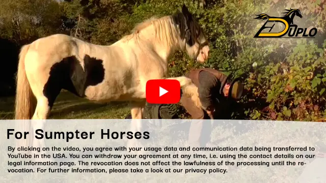 a packer lifts the hoof of his pack horse